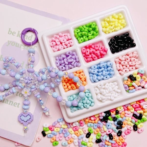 Colorful acrylic peanut beads kit in 12-grid storage box with flower charm sample