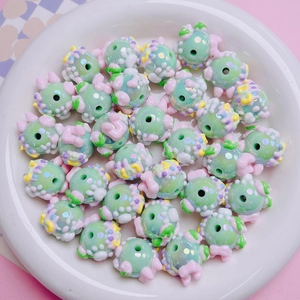 Macro detail of hand-painted mint green acrylic 3D beads for DIY jewelry making