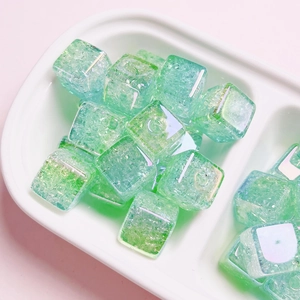 Macro shot of mint green acrylic square beads with crackle texture for DIY jewelry making
