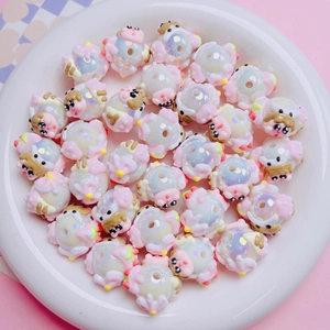 Macro shot of pig-shaped pearlescent acrylic beads with holes for DIY craft jewelry