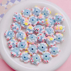 Detail of blue hand-painted acrylic beads with Nice text and smiley faces for DIY jewelry