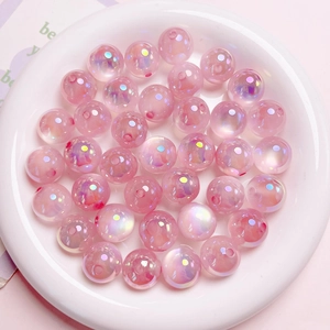 Detailed view of pink iridescent acrylic beads with UV aurora coating for jewelry making