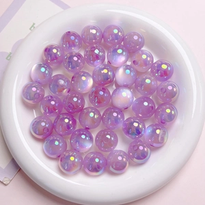 Detailed macro view of purple UV coated iridescent acrylic beads with center holes for DIY crafts