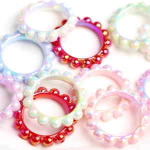 Iridescent acrylic beaded rings in vibrant colors like red, pearl white, and light blue