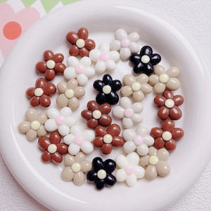 Macro detail of 20mm flower acrylic beads in cream and brown for DIY jewelry making