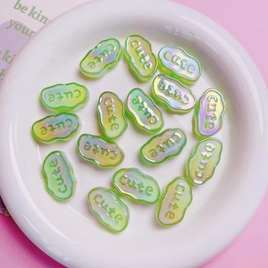 Macro detail of cloud shaped acrylic beads with cute lettering and aurora finish