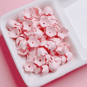 Macro shot of pink lily of the valley acrylic beads for DIY jewelry making and crafts