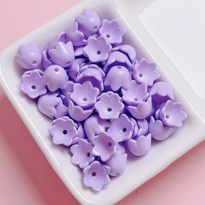 Macro detail of purple lily-of-the-valley acrylic flower beads for DIY jewelry making