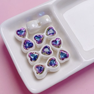 Detailed view of iridescent heart zircon bow charms for DIY jewelry and phone chains