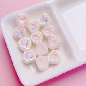 Close-up of heart-shaped iridescent zircon beads with pearlescent finish for DIY crafts