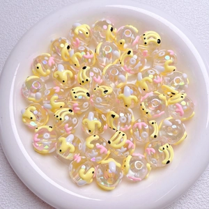 Macro detail of hand-painted strawberry beads with aurora coating for DIY jewelry making