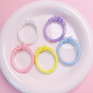 Detailed view of 5-piece set of colorful bow resin charms for DIY jewelry making