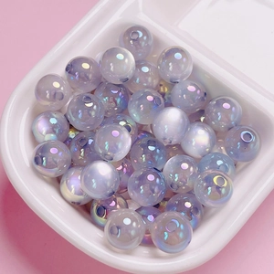 Macro detail of iridescent UV coated acrylic beads with cat eye luster for DIY crafts