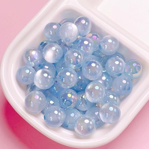 Macro detail of iridescent blue aurora jelly acrylic round beads for DIY jewelry making