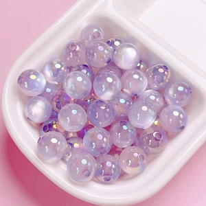 Macro shot of iridescent lavender acrylic beads with central drill holes for DIY jewelry