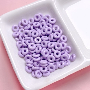Close-up of polished purple alloy donut spacer beads for DIY jewelry making