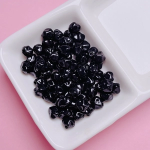 Primer plano de cuentas de aleación negra de 7mm en forma de estrella para joyería DIY