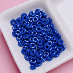 Macro shot of polished deep blue alloy donut beads for DIY keychain jewelry making