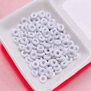Close-up of white mini doughnut spacer beads for DIY jewelry and phone chain making