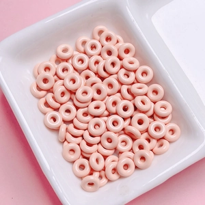 Macro shot of glossy pink doughnut beads for DIY crafts and jewelry making