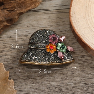 Macro shot of vintage hat brooch with crystals and dimensions 2.6cm by 3.5cm