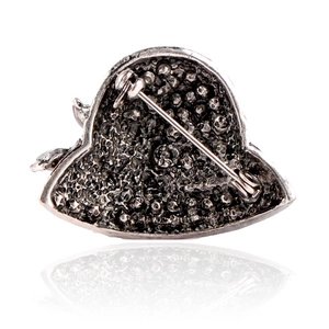 Macro shot of gothic brooch back with skull relief texture and metal safety pin