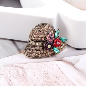 Close-up of vintage hat brooch with brown rhinestones and colorful crystal flowers
