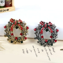 Close-up of vintage Christmas wreath brooches with colorful rhinestones and red bows