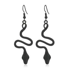 Macro view of matte black snake earrings featuring Gothic scales and S-curve design
