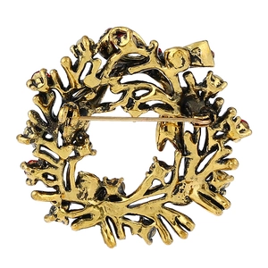 Back view of antique gold floral brooch with red rhinestones and secure pin closure