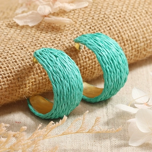 Green woven C-shape hoop earrings with gold metal accents in bohemian style