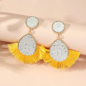 Bohemian crystal fan-shaped tassel drop earrings in bright yellow on a pedestal