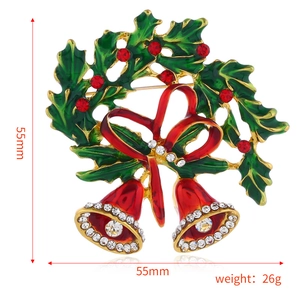 Detail view of a 55mm Christmas bell brooch with red green enamel and rhinestones