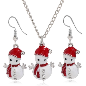 Close-up of Christmas snowman jewelry set with white enamel and red hats and sparkling rhinestones