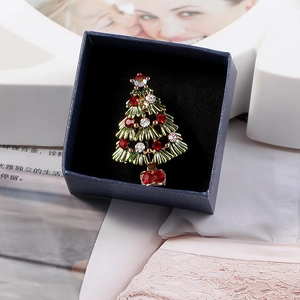 Detailed view of an alloy Christmas tree brooch with colorful rhinestones in a gift box