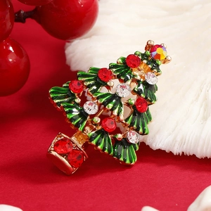 Exquisite golden Christmas tree brooch with green enamel and vibrant sparkling crystals