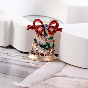 Macro detail of Christmas bell brooch featuring golden hollow craft and colorful rhinestones