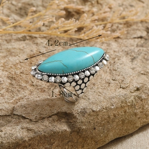 Macro detail of vintage turquoise ring with silver scale texture and crystal accents