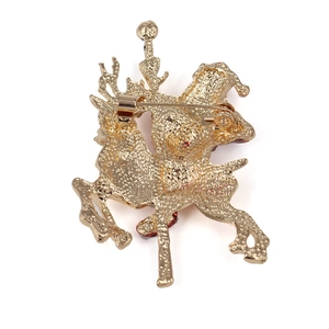 Macro shot of the gold-plated metal back of Santa brooch with safety pin fastener
