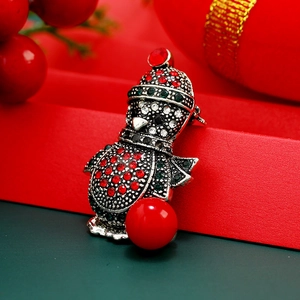 Sparkling rhinestone penguin brooch with red bead in festive vintage silver setting
