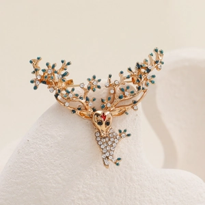 Broche de renne luxueuse en alliage doré avec strass blancs et détails en émail bleu