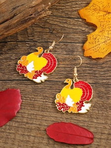 Detail of colorful turkey drop earrings with maple leaf accents for Thanksgiving style