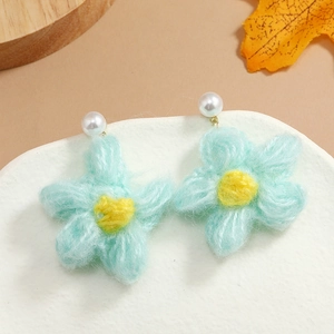 Handcrafted crochet flower earrings in light blue and yellow with white pearl bead