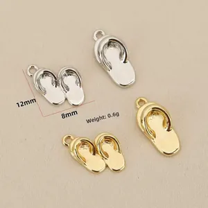Macro shot of gold and silver 3D flip-flop pendants showing 12mm x 8mm dimensions