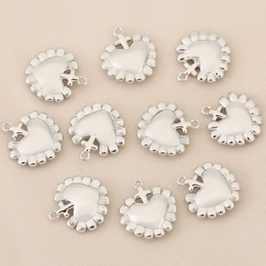 Set of ten silver heart-shaped jewelry pendants with cross-detailed hanging loops