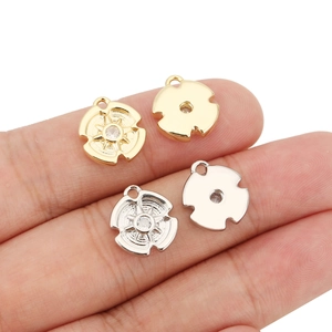 Detail of four 18k gold plated star compass pendants with zircons for DIY jewelry