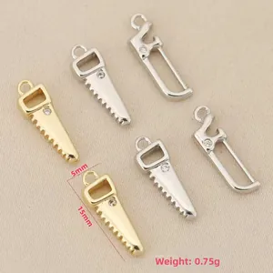 Macro detail of 15x5mm mini saw pendant in 18k gold plated copper with small crystal