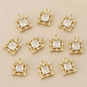 Macro shot of 18k gold plated square charms with zircon stones for jewelry making