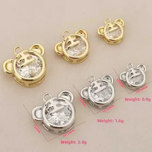 Detailed view of 18k gold tiger pendants with cubic zirconia and size measurements