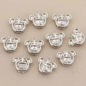 Close-up of 18k gold plated tiger pendants with large clear cubic zirconia stones
